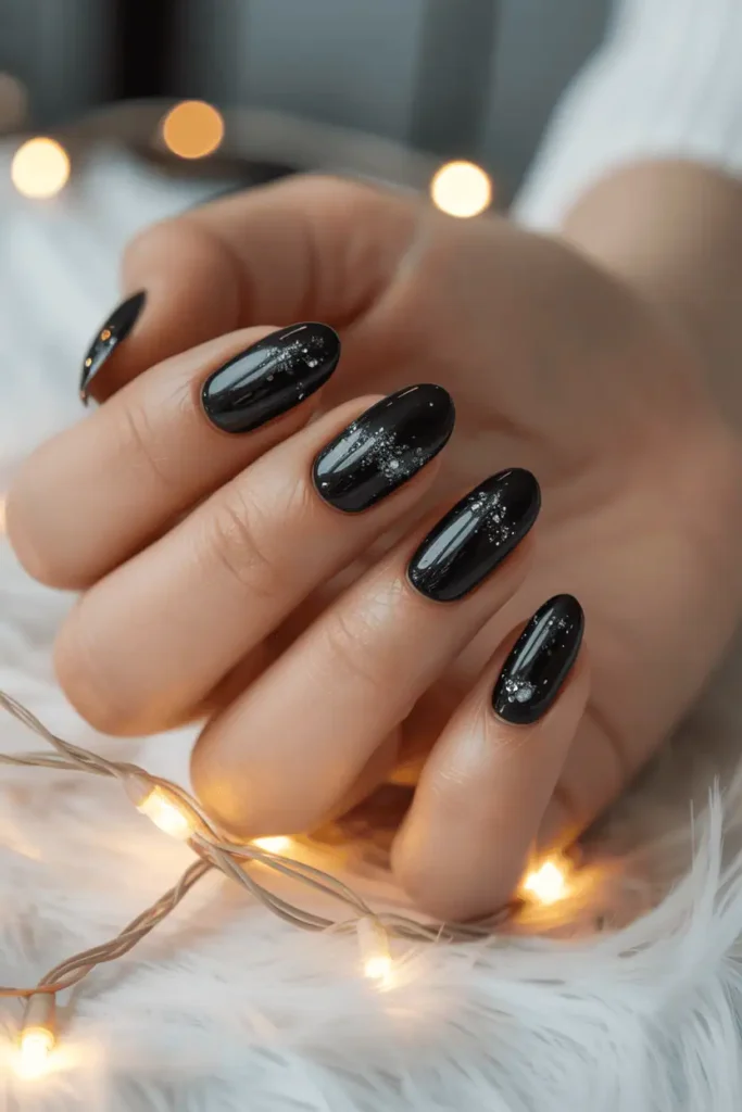 black nails with fine silver microshimmer, sleek glossy finish, elegant winter vibe, soft holiday lights background, realistic hands