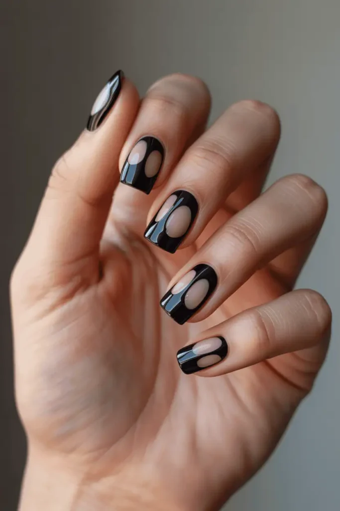 black nails with geometric cut-out shapes and negative space panels, bold architectural look, clean neutral background, realistic hands, soft modern lighting