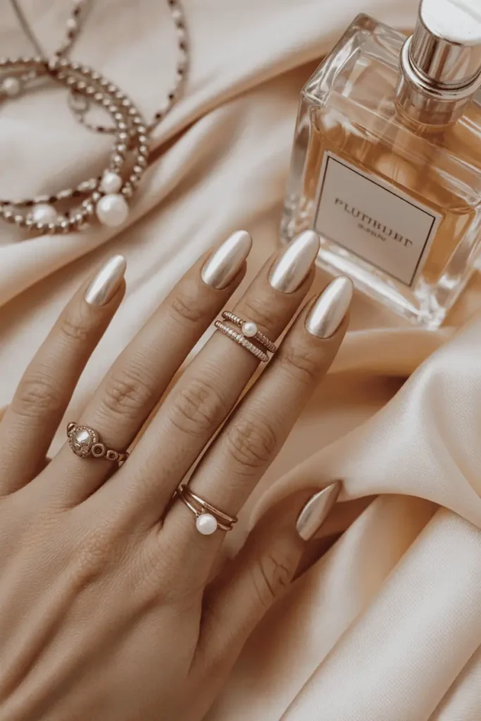 Pearlized nude manicure, refined neutral background, elegant and clean.
