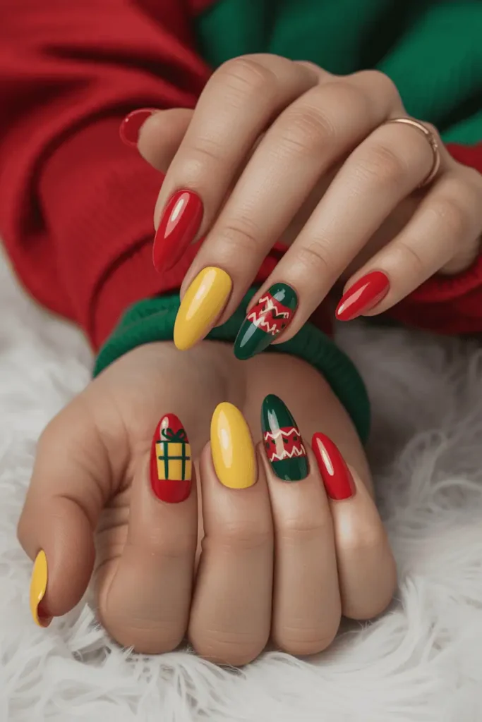 bright red, green, and yellow nails with gift box and sweater-pattern accents, playful festive mood, cozy Christmas backdrop, realistic hands