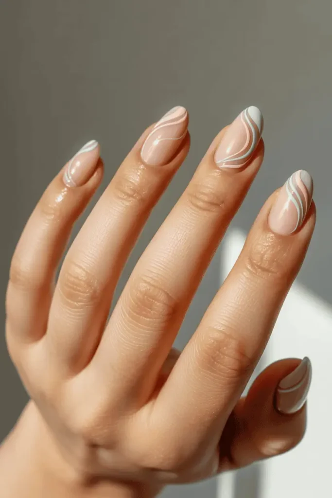 nude base nails with thin pastel swirl designs, minimalist modern nail art, soft spring colors, short nails, natural lighting, clean neutral background, realistic nail photography, pinterest vertical 2:3, no text