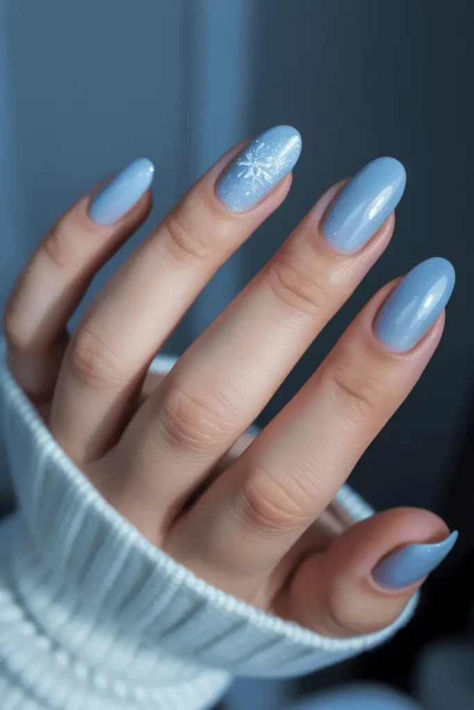 icy baby blue nails with soft shimmer or glossy shine, frosty winter aesthetic, cool tone background, snow-inspired lighting, realistic hands