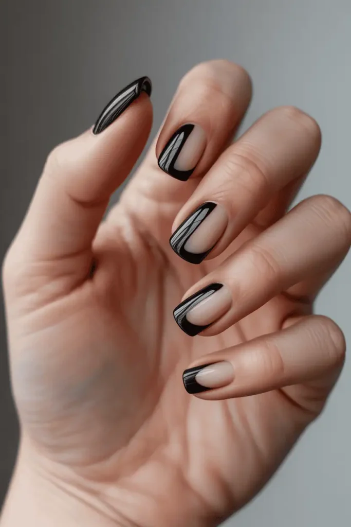 black split french tips divided vertically matte on one half and glossy on the other, graphic modern composition, neutral background, realistic hands, soft lighting