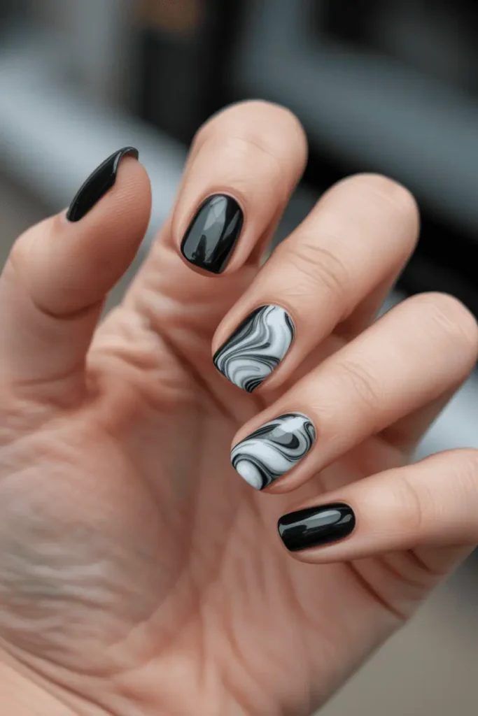 black nails with white and gray marble swirl details, sleek artistic pattern, high contrast, neutral background, realistic hands, glossy texture, Pinterest hero photo