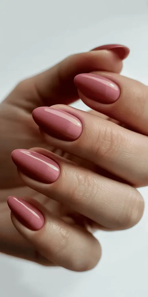 Almond nails with modern French manicure featuring rose gold metallic chrome tips on nude pink base