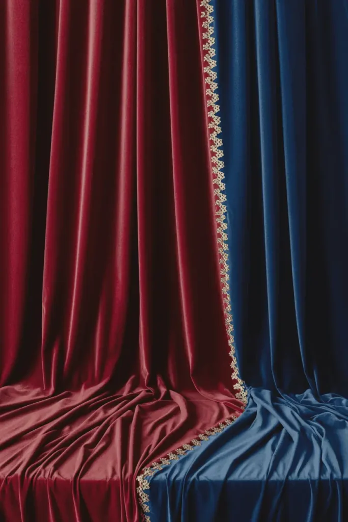 Rich velvet fabrics in holiday colors arranged with warm lights.