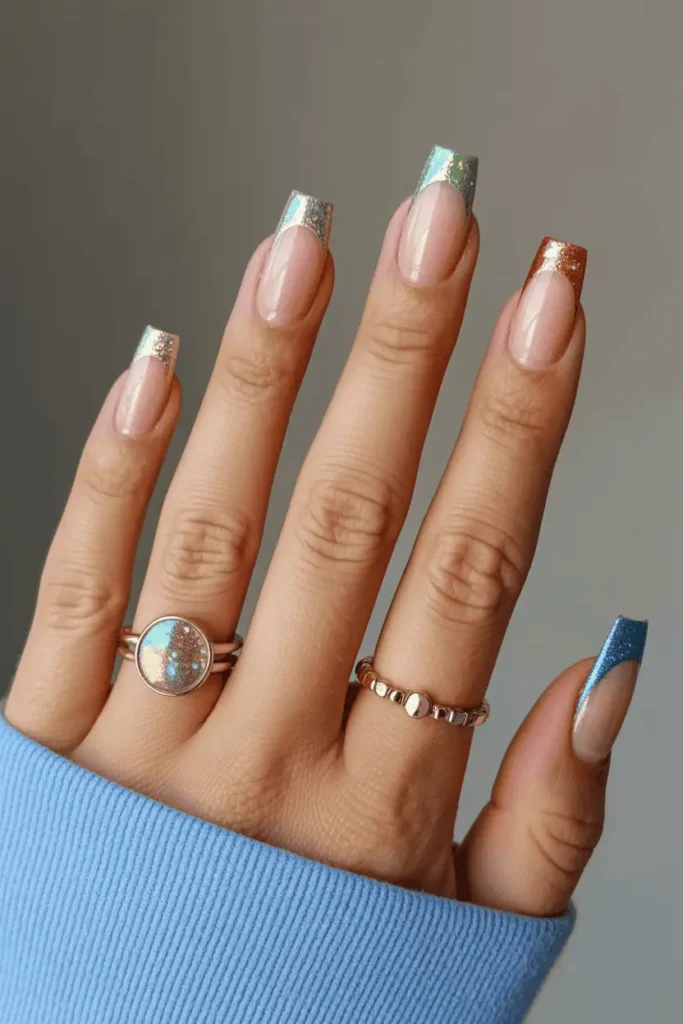 clear or nude nails with multicolor glitter French tips, rainbow sparkles, bright festive vibe, cozy holiday lighting, realistic hands, Pinterest hero look