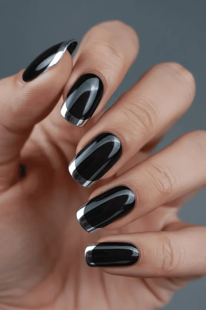 black french tips outlined with thin silver chrome edges, sleek futuristic style, glossy finish, elegant composition, realistic hands, soft reflections, Pinterest-friendly lighting