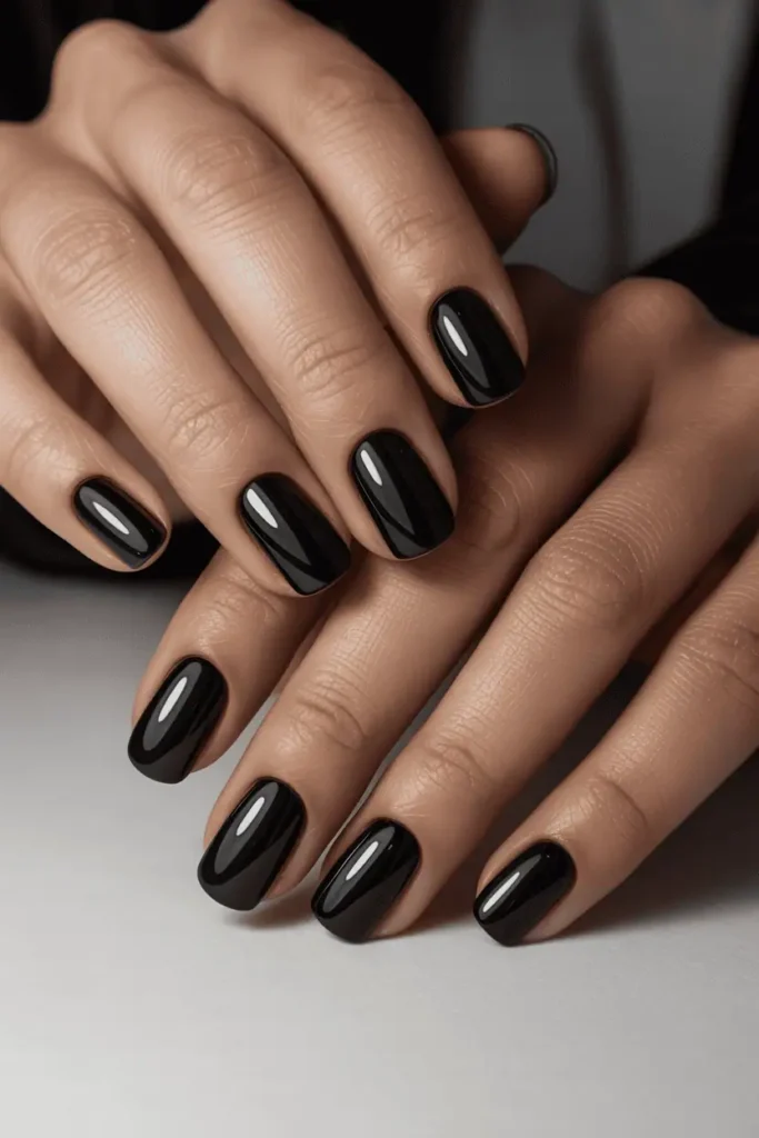 black nails with alternating glossy and matte finishes, sharp clean lines, minimal edgy contrast, close-up of realistic hands, soft neutral background, modern lighting, high-detail texture, Pinterest hero photo
