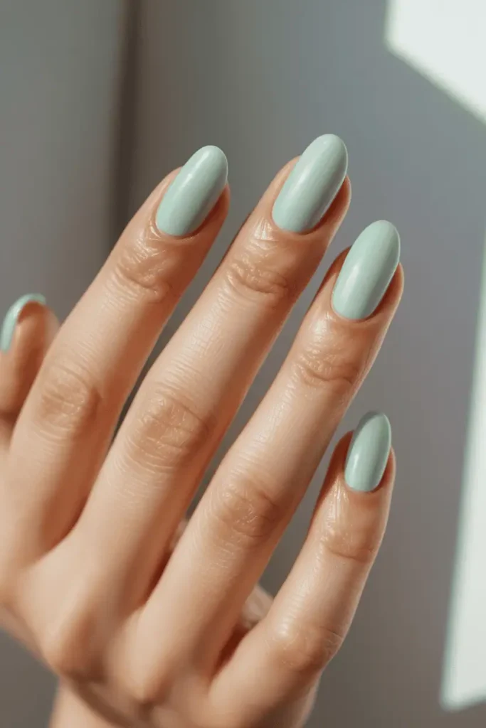 mint green pastel nails with smooth glossy finish, realistic hands, soft natural daylight, clean neutral background, minimal spring styling, high detail, natural skin tones