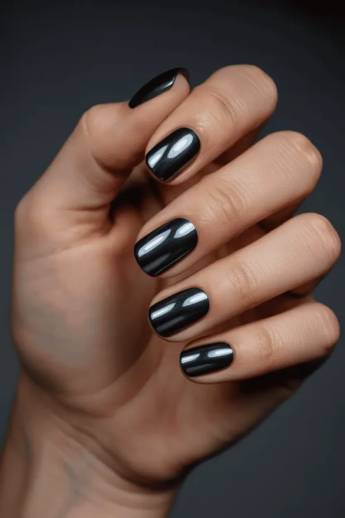 black nails with oil-slick chrome powder, futuristic metallic sheen, high contrast, dramatic lighting, realistic hands, minimal dark background