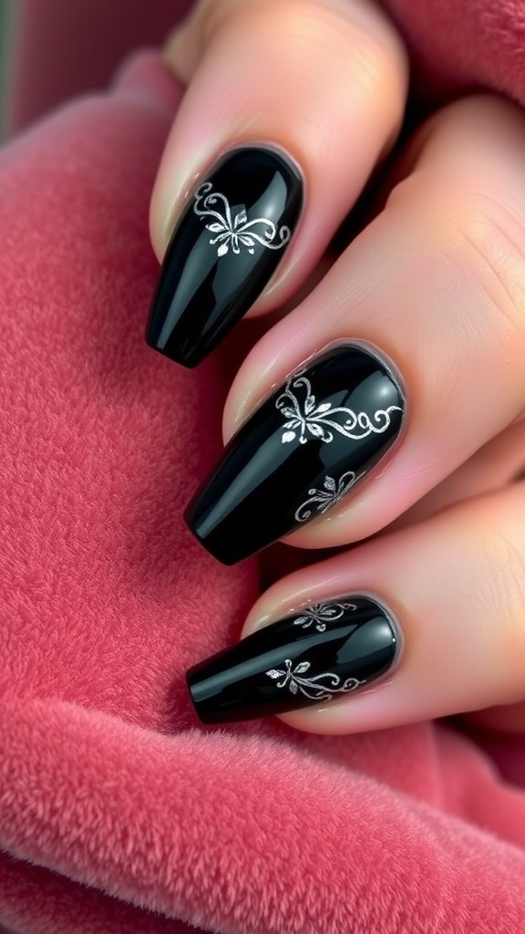 Glossy black nails with intricate silver accents, showcasing elegance and style.